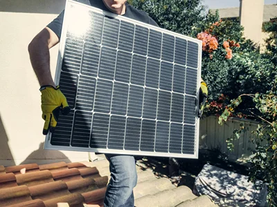 Man Carrying Solar Panel